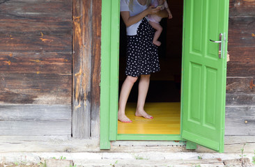 Woman with baby on open door