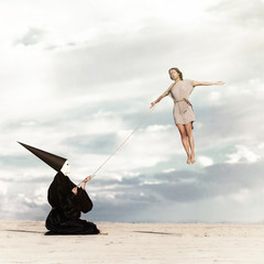 Woman flying like a kite driven by mysterious person