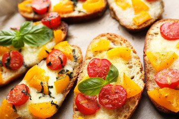 Tasty bruschetta with tomatoes on pan, on old wooden table