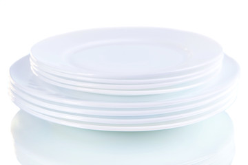 Set of white dishes on table on light background