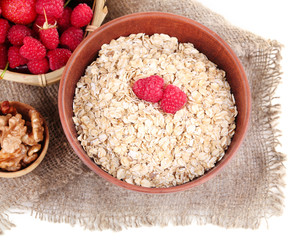 Wooden bowls of berries on sackcloth isolated on white