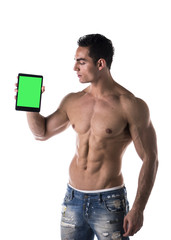 Fototapeta premium Sexy muscular shirtless young man holding a blank tablet PC