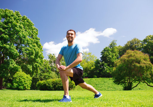 smiling man stretching outdoors