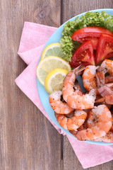 Plate of fresh boiled prawns with tomatoes, lettuce, lemon and