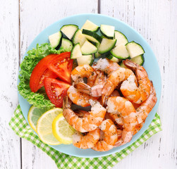 Plate of fresh boiled prawns with tomatoes, lettuce, lemon and