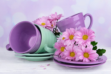 Obraz na płótnie Canvas Bright cups and saucers with flowers