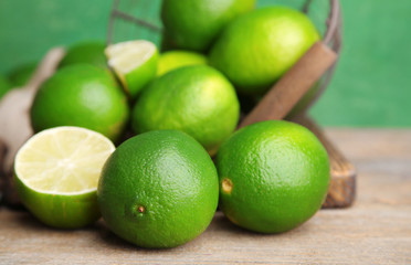 Fresh juicy limes on old wooden background