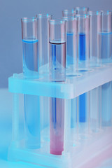 Test tubes with liquid on grey background
