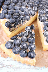 Tasty homemade pie with blueberries on wooden table