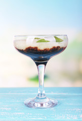 Melon smoothie in glass on table on bright background