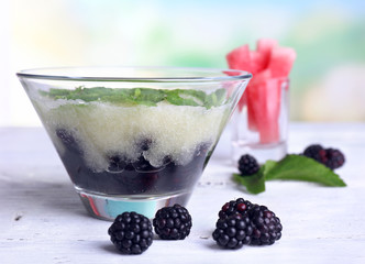 Melon smoothie in glass bowl on table on bright background