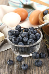 Fresh blueberries and milk products on wooden table