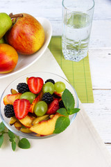 fresh tasty fruit salad on wooden table