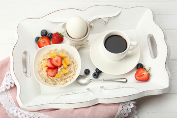 Delicious breakfast with coffee, egg and oatmeal