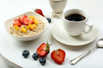Delicious breakfast with coffee, egg and oatmeal
