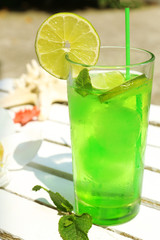 Refreshing cocktail on table, outdoors