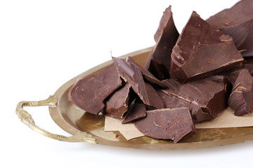 Cracked chocolate block on paper napkin isolated on white