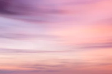 Zelfklevend Fotobehang Defocused sunset sky background  with blurred panning motion. © volgariver