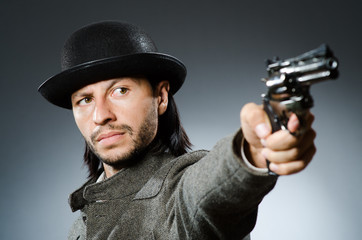 Fototapeta na wymiar Man with gun and vintage hat
