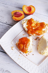 tasty bun with homemade jam on wooden table