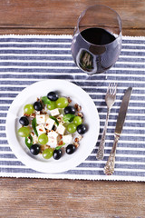 beautiful still life with wine and salad on wooden background