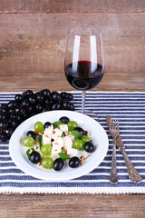 beautiful still life with wine and salad on wooden background