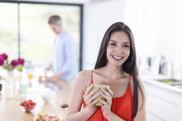 couple in the kitchen in the morning woman at foreground