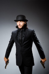 Man wearing vintage hat with gun