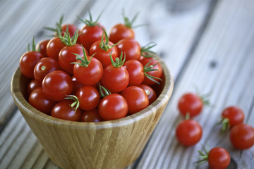 Cherry tomatoes in a wooden bowl.