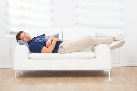 Man Sleeping On Sofa At Home