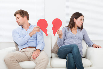Couple Ignoring Each Other On Sofa