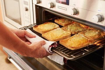 Cheese On Toast Being Grilled In Oven