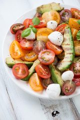 Grilled avocado, tomatoes and mozzarella salad, vertical shot