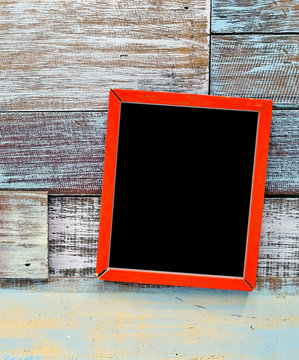 Red wooden frame hanging on a wooden board
