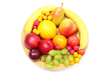 Fresh ripe fruits on wooden plate