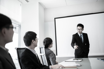 businessman giving a presentation to his colleagues