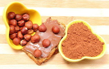 Hazelnut and slices of bread with chocolate cream