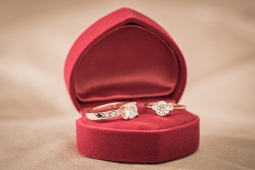 Wedding rings in a box on a brown background