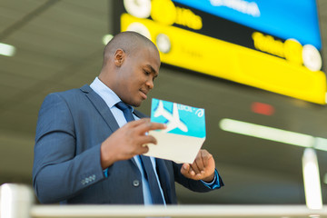 african american business traveller checking time