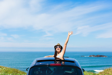 Woman on car vacation travel waving