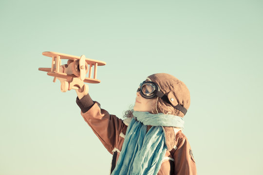 Happy child playing with toy airplane