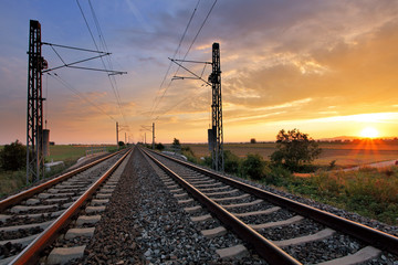 Naklejka na ściany i meble Dramatic sunset over railroad