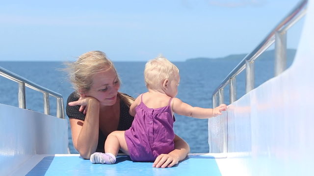 child plays mother on ship