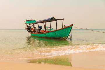 Fototapeta na wymiar Boat on the beach in Sihanoukville, Cambodia