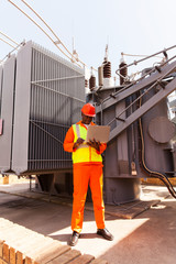 african power company technical worker using laptop computer