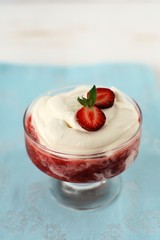 Strawberry with cream in a glass vase