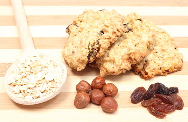 Oatmeal cookies with raisins and hazelnut on wooden background