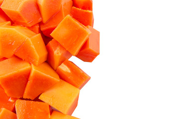 Bite sized papaya fruit over white background