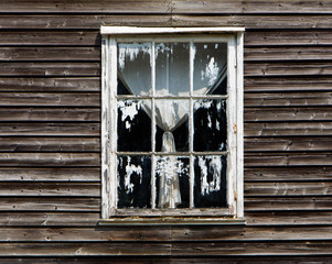 Old window with a curtain of wooden house
