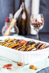 Ratatouille in white casserole on a dark background